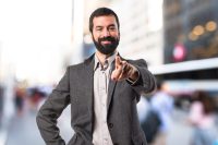 man pointing at camera to indicate pointing at customer