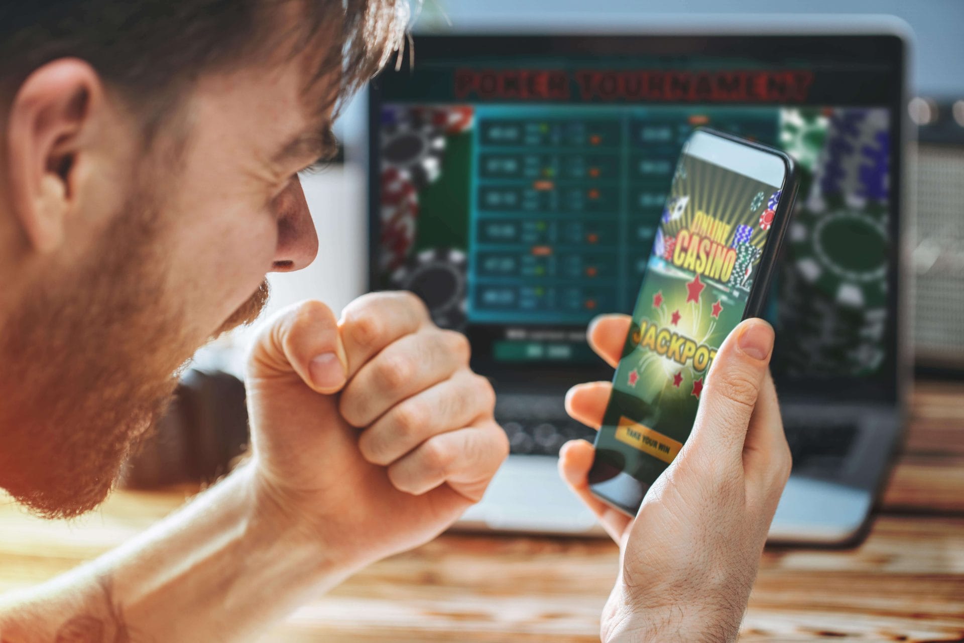 Hand holding smartphone displaying an online betting application